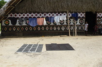 Colombia, Piraparana, with clothes drying next to a traditional Tukano maloca, Solar panels and battery.