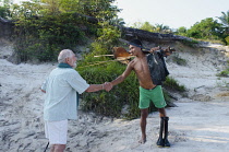 Colombia, Piraparana, Documentary film-maker Brian Moser greets a Tukano indian in the community of Piedra Ni.