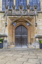 England, Oxfordshire, Oxford, Magdalen College, St Johns Quad, Timber doorway under the  west window of the college chapel with coat of arms and statues of John the Baptist, Edward 1V, St Mary Magdale...