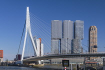 Holland, Rotterdam, View of the Erasmusbrug or Erasmus Bridge over the Nieuwe Maas River with the 3 sectioned De Rotterdam Building in the background.