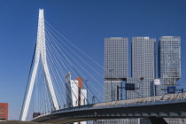 Holland, Rotterdam, View of the Erasmusbrug or Erasmus Bridge over the Nieuwe Maas River with the 3 sectioned De Rotterdam Building in the background.