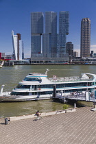 Holland, Rotterdam, The Nieuwe Maas River with the De Rotterdam Building in the centre flanked by the KPN Telecom Tower building on the left and the New Orleans Tower on the right with tourists disemb...