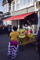 Portland Road, Dragon dance outside Asiana shop for Chinese New Year 2023, the year of the Rabbit.