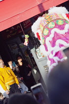 Portland Road, Dragon dance outside Asiana shop for Chinese New Year 2023, the year of the Rabbit.