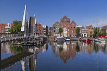 Holland, Rotterdam, The double drawbridge known as the VOC Bridge across the Achterhaven with the Piet Hein Building named after a 16th century navigator born locally.