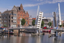 Holland, Rotterdam, The double drawbridge known as the VOC Bridge across the Achterhaven with the Piet Hein Building named after a 16th century navigator born locally.