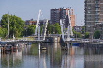 Holland, Rotterdam, The double drawbridge known as the VOC Bridge across the Achterhaven with a statue of Piet Hein who was a 16th century navigator born locally.