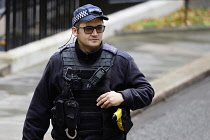 England, London, Westminster, Downing Street, AFO Policeman wearing body protection and baseball cap.