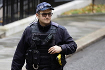 England, London, Westminster, Downing Street, AFO Policeman wearing body protection and baseball cap.