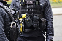 England, London, Westminster, Downing Street, Detail of AFO Police officers wearing body protection with radio, taser gun and handcuffs.
