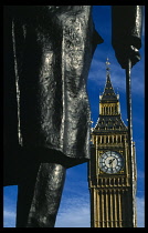 England, London, Big Ben seen behind detail of statue of Sir Winston Churchill in the foreground.