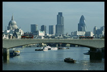 England, London, Skyline seen over the river Thames with bridge in the foreground.