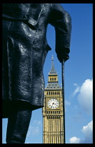 England, London, Part view of statue of Winston Churchill with Big Ben behind.