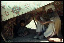 Afghanistan, General, Nomad family inside tent to avoid the midday heat.