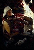 Afghanistan, General, Kirghiz woman tending baby in cradle.