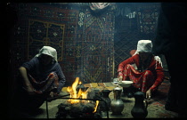 Afghanistan, Nomads, Kirghiz, Yurt interior with women sat around the fire.
