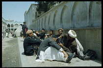 Afghanistan, People, Street barber working on the pavement outside a mosque.