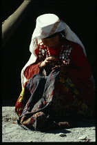 Afghanistan, General, Kirghiz woman sewing.
