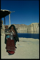 Afghanistan, General, Woman carrying baby beside the Lake Band i Amir near Bamiyan.