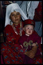 Afghanistan, General, Portrait of nomadic Kirghiz woman and child in traditional dress.