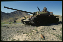 Afghanistan, Kabul, Damaged Soviet RR3.18 tank with live ammunition around it.
