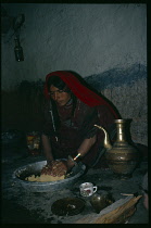 Afghanistan, East, General, Pashtun woman making dough inside home.