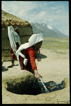 Afghanistan, General, Kirghiz woman cooking outside yurt.