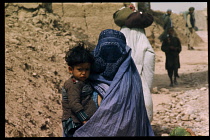 Afghanistan, General, Woman in purdah carrying child.