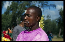 MAURITIUS, People, Body Decoration, Creole Christian man with mouth peircing at the Hindu Festival of Cavadee.