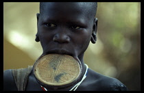 ETHIOPIA, General, Girl of the Mursi tribe wearing large lip plate.