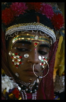 INDIA, People, Body Decorations, Girl wearing elaborate facial decorations for the Ramulla Festival.
