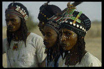 NIGERIA, North, General, Wodaabe nomadic tribesmen with painted faces and wearing decorated head dresses to perform dance called the yake.