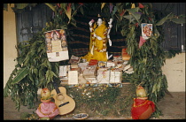 India, General, Offerings and Hindu text and figures in small shrine.