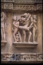 India, Madhya Pradesh, Khajuraho, Detail of erotic sculpture on ancient temple exterior.