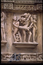 India, Madhya Pradesh, Khajuraho, Detail of erotic sculpture on ancient temple exterior.