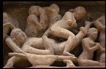 India, Madhya Pradesh, Khajuraho, Detail of erotic carvings on ancient temple exterior.