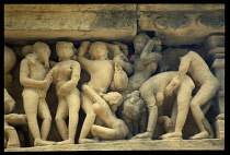 India, Madhya Pradesh, Khajuraho, Detail of erotic stone carvings on ancient temple exterior.