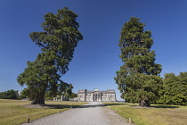 Ireland, County Laois, Emo Court, Facade of the house framed by two tall trees, Emo Court is a quintessential neo-classical mansion designed by the famous architect James Gandon1790.