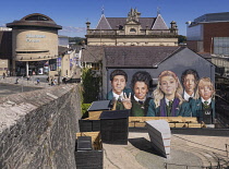 Northern Ireland, Co.Derry, Derry city, Mural on Badger's Bar featuring the cast of Derry Girls, a Channel 4 comedy series which follows a group of five secondary school students navigating adolescenc...