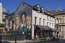 Northern Ireland, Co.Derry, Derry city, Mural on Badger's Bar featuring the cast of Derry Girls, a Channel 4 comedy series which follows a group of five secondary school students navigating adolescenc...