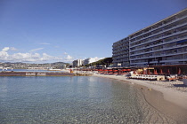 France, Provence-Alps, Cote d'Azur, Antibes Juan-les-Pins, Beach with tourists sunbathing and swimming in the sea.