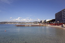 France, Provence-Alps, Cote d'Azur, Antibes Juan-les-Pins, Beach with tourists sunbathing and swimming in the sea.