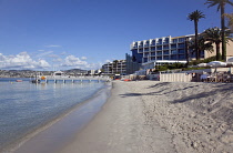 France, Provence-Alps, Cote d'Azur, Antibes Juan-les-Pins, Beach with tourists sunbathing and swimming in the sea.