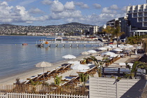 France, Provence-Alps, Cote d'Azur, Antibes Juan-les-Pins, Beach with tourists sunbathing and swimming in the sea.