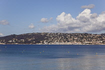 France, Provence-Alps, Cote d'Azur, Antibes Juan-les-Pins, View across sea to headland with hotels and buildings.