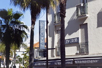 France, Provence-Alps, Cote d'Azur, Antibes Juan-les-Pins, Exterior of the New Orleands cafe and bar with palm trees.