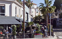 France, Provence-Alps, Cote d'Azur, Antibes Juan-les-Pins, Exterior of cafe bar with outdoor seating.