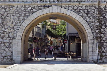 France, Provence-Alps, Cote d'Azur, Antibes, Archway through city walls into the old town.