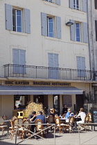 France, Provence-Alps, Cote d'Azur, Antibes, People sat outside brasserie.