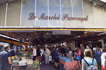 France, Provence-Alps, Cote d'Azur, Antibes, Provencal food market busy with tourists and locals buying fresh fruit and vegetables.